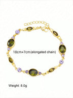 gold bracelet with green stones