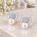 Silver bow earrings with large pearl drops