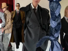 “Oversized tailored suits with ties and long coats styled in modern androgynous fashion trend.”