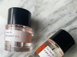 D’Orsay perfume bottles displayed on marble surface with minimalist black caps