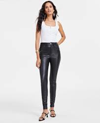 Modern outfit showcasing fitted leather trousers as a comeback fashion trend.