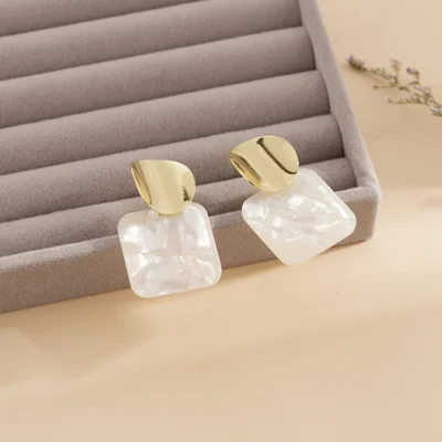 Close-up square sequin earrings geometric shine detail