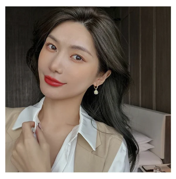 Women wearing minimalist opal earrings fashion look