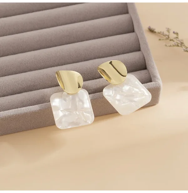 Close-up square sequin earrings geometric shine detail