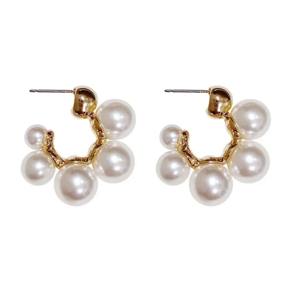 Close-up pearl earrings with metal detailing