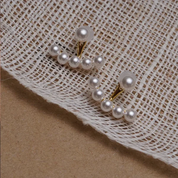 Elegant pearl pendant earrings close-up studio shot