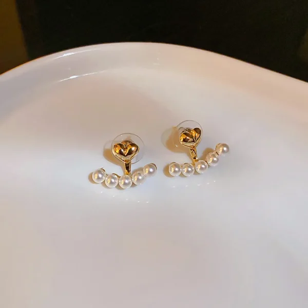 Elegant imitation pearl earrings close-up detail