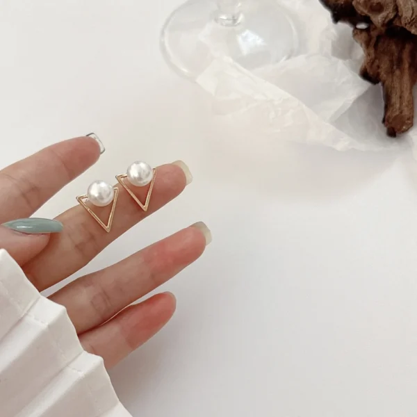 Close-up pearl triangle earrings elegant detail