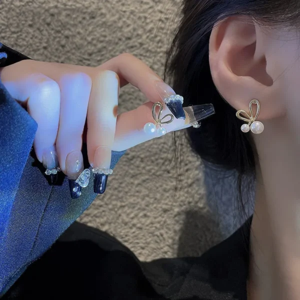 Elegant metal bow stud earrings close-up shot