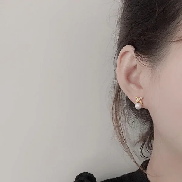 Side angle of CZ pearl cross shape stud earrings