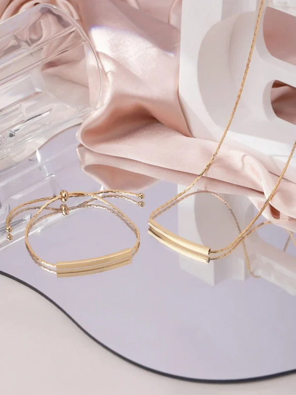 Close-up of minimalist copper geometric necklace and bracelet set